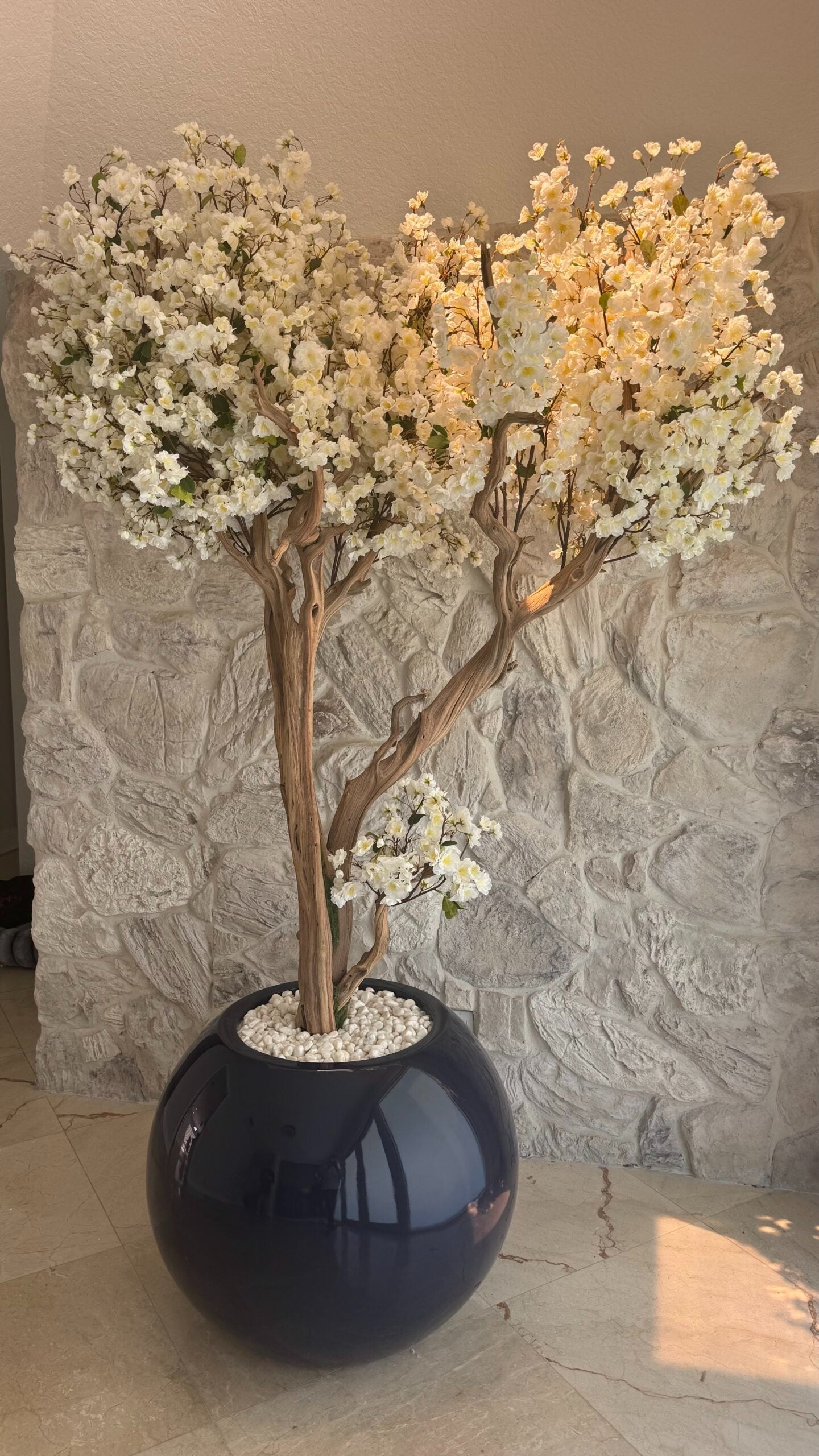 Weißer Kirschblütenbaum in einer dunkelblauen Vase