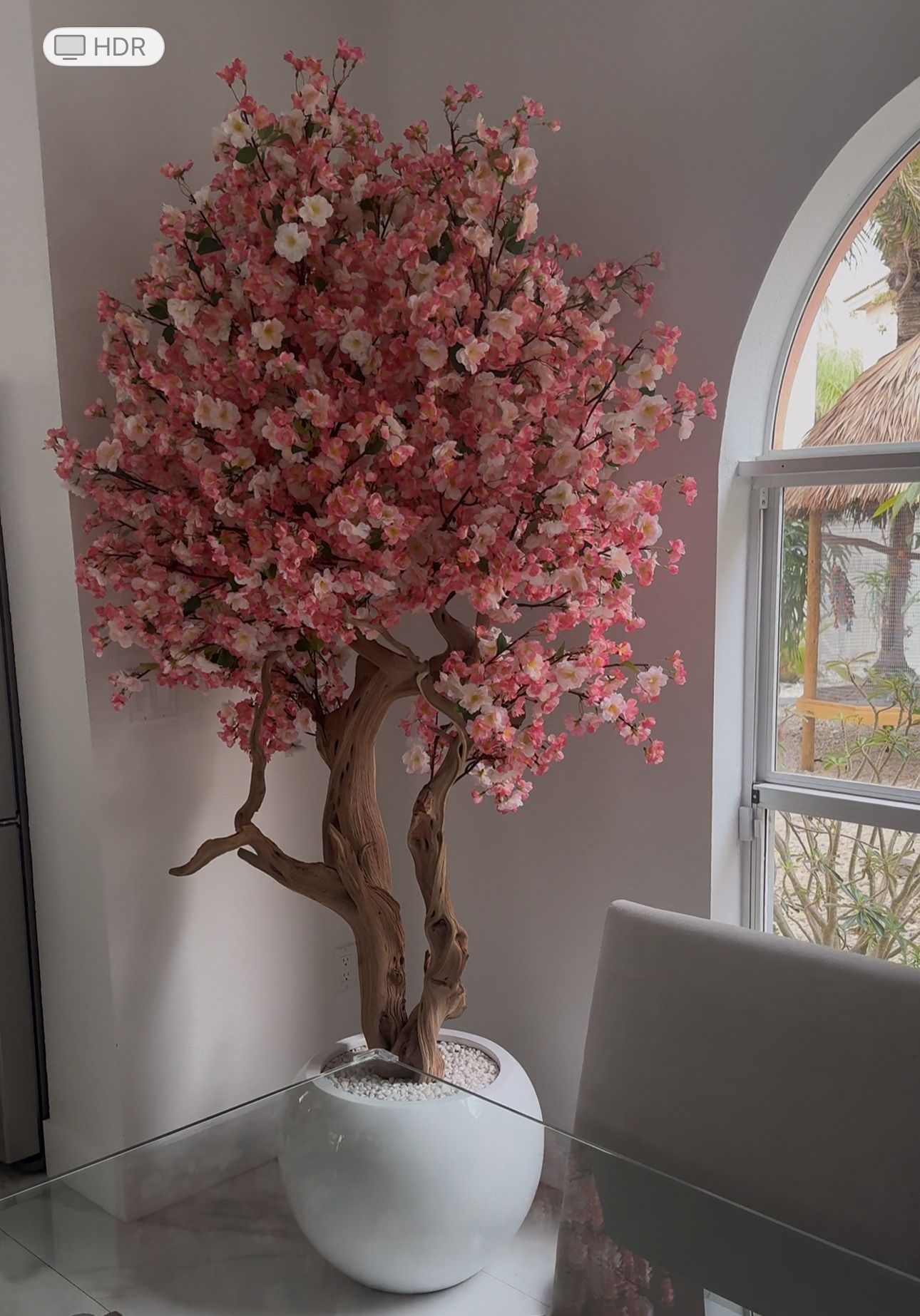 Rosa Kirschblütenbaum in einer glänzend weißen runden Vase